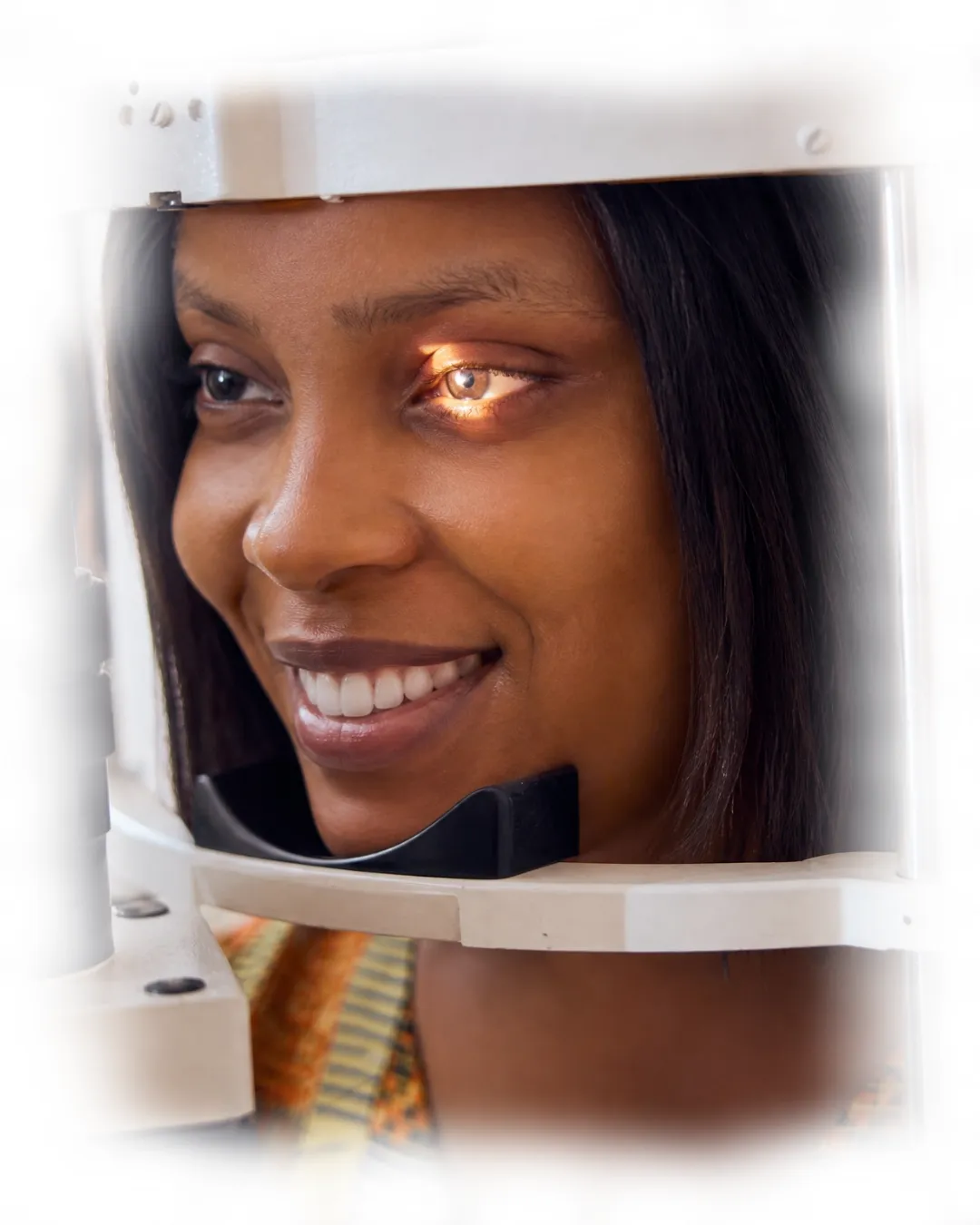 Woman undergoing a digital eye screening at IrisCare Eye Clinic, positioned at a slit lamp microscope while an optometrist examines the front structures of her eyes as part of a comprehensive eye examination.